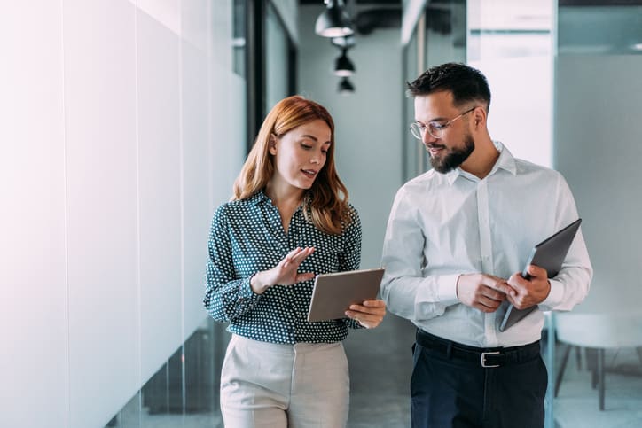 Man and woman looking at vat compliance solution on ipad