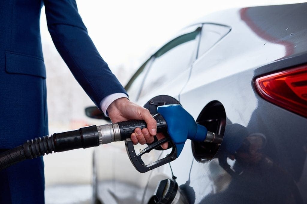 Businessman fueling his car