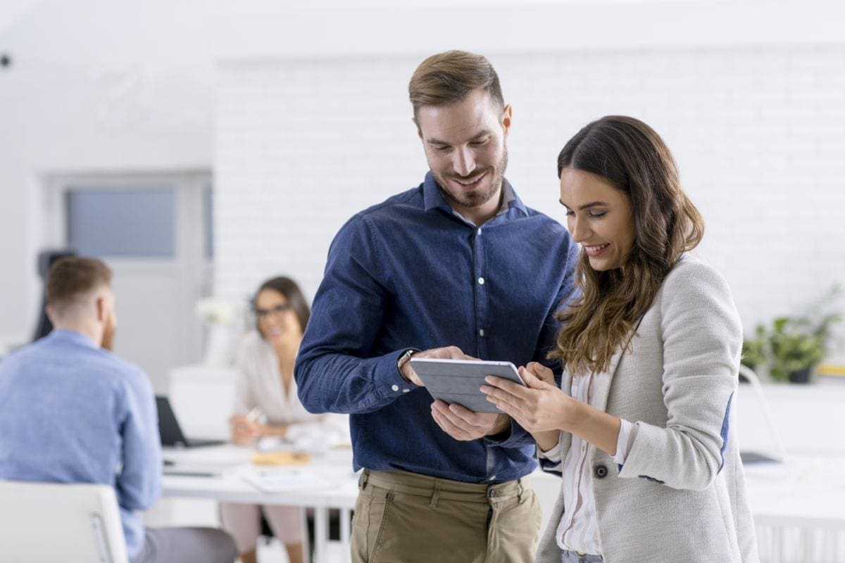 Man and woman looking at ipad